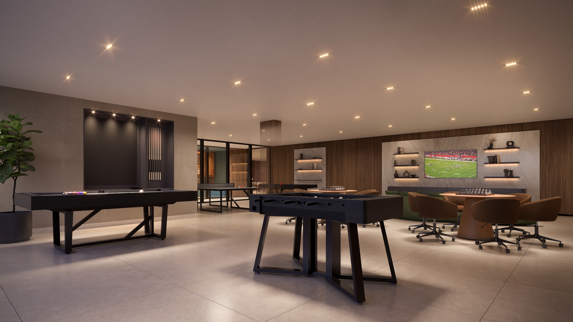 Espaço de jogos interno com mesas, lounge e televisão