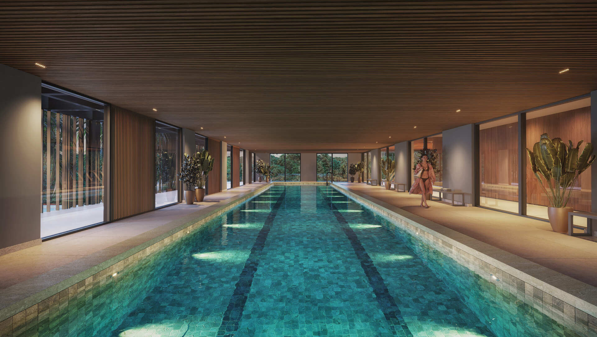 Piscina coberta semiolímpica com paisagismo e iluminação aconchegante
